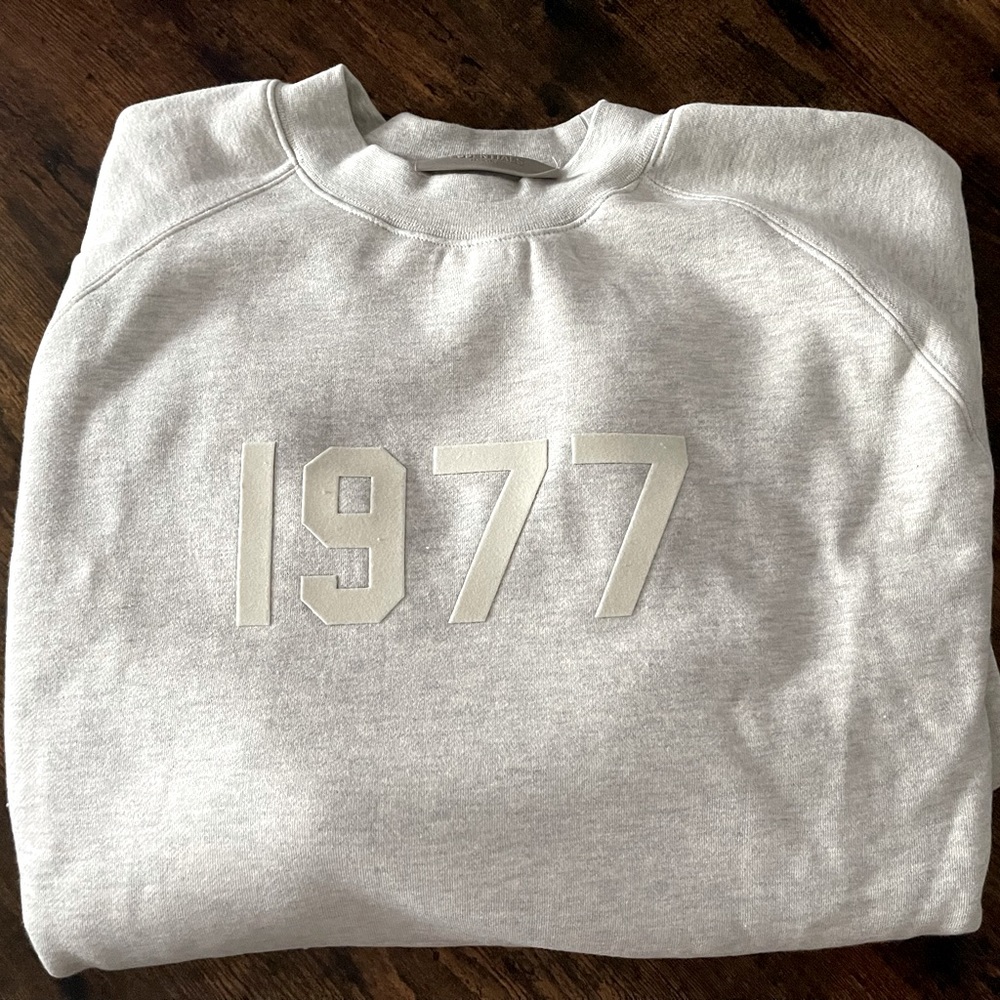 Brand New never worn Fear of God essentials crew neck sweater. The color Oatmeal